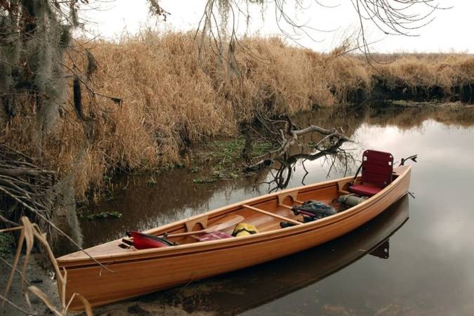 The Freedom 15 is a modern, efficient wood-strip canoe for one or two paddlers