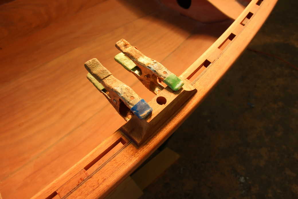 Glue the rowlock mounting blocks to the rails