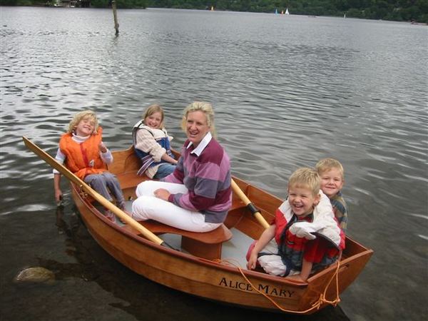 Children and Grandmother having fun messing about in Granddad's home made clinker rowing boat