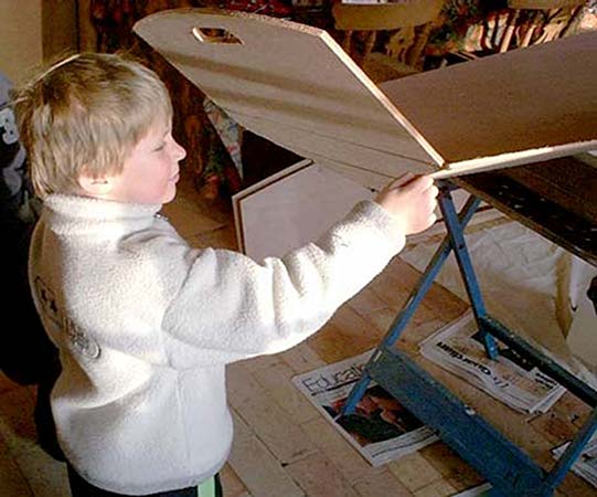 A boy building his first rowing boat from Fyne Boat Kits