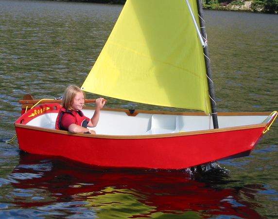 Girl having fun learning to sail a small boat