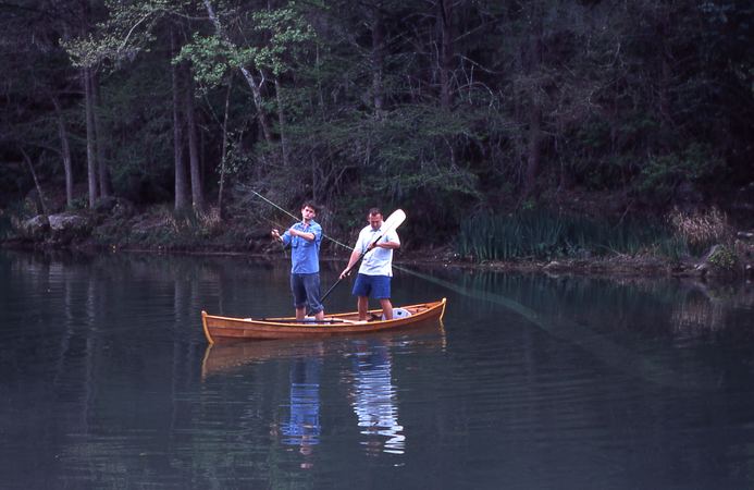 Fly fishing standing in a canoe built at home from plans
