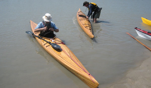 Great Auk stable cedar-strip sea kayaks with plumb ends, soft chines and a rounded bottom