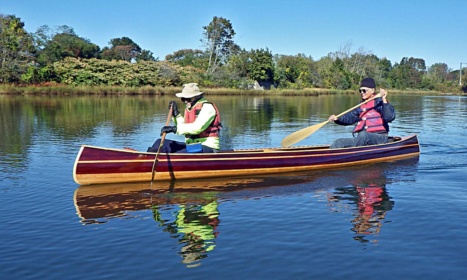 The Mystic River canoe is a traditional wood-strip tandem canoe for 