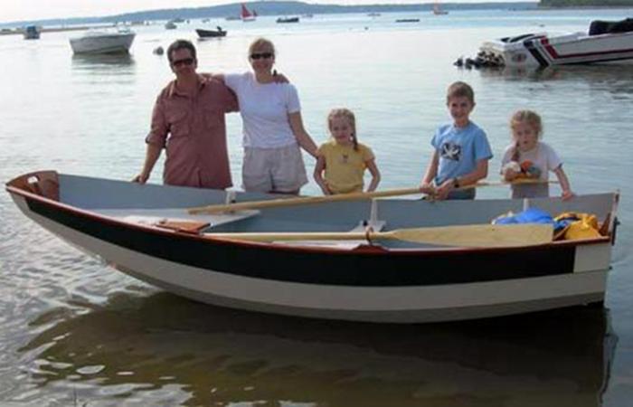 Proud family showing off the Passagemaker clinker rowing boat they built