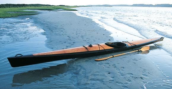A beautiful Pax 20 wooden kayak on the beach