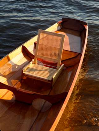 Folding cane seat for a canoe or boat