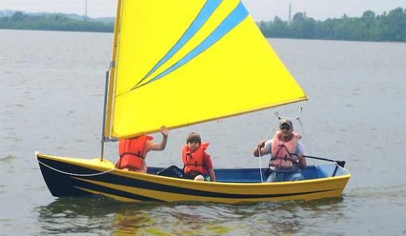 Colourful sails on the boys home made skiff