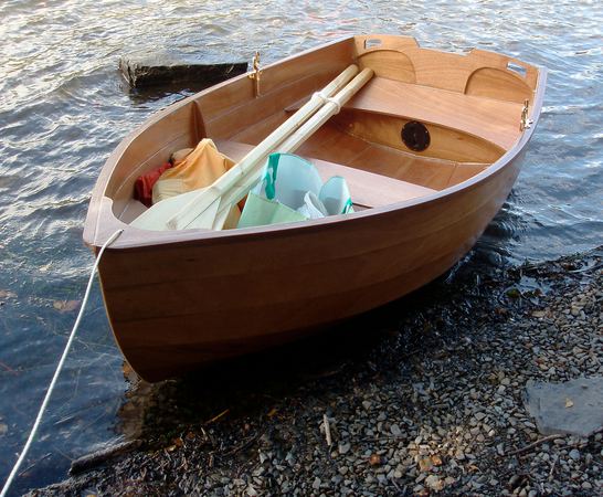 A wooden stem dinghy used as a tender to a yacht