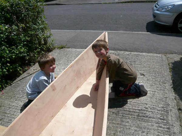 Stitching a wooden canoe together in the garden