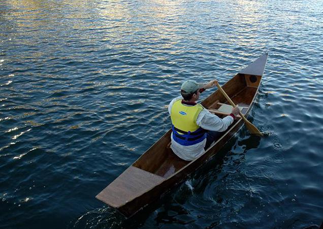 Solo in his own build wooden canoe
