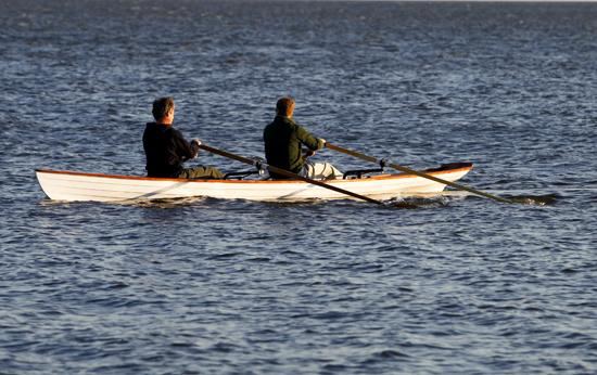 Two person clinker style rowing boat in rough water