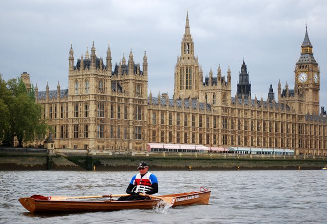 Home built wherry rows on Thames past Houses of Parliament London made from a Fyne Boat Kit
