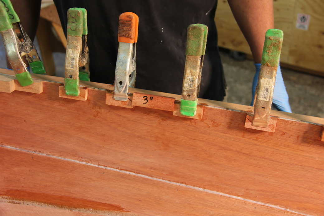 Clamp the spacer blocks in place on the hull