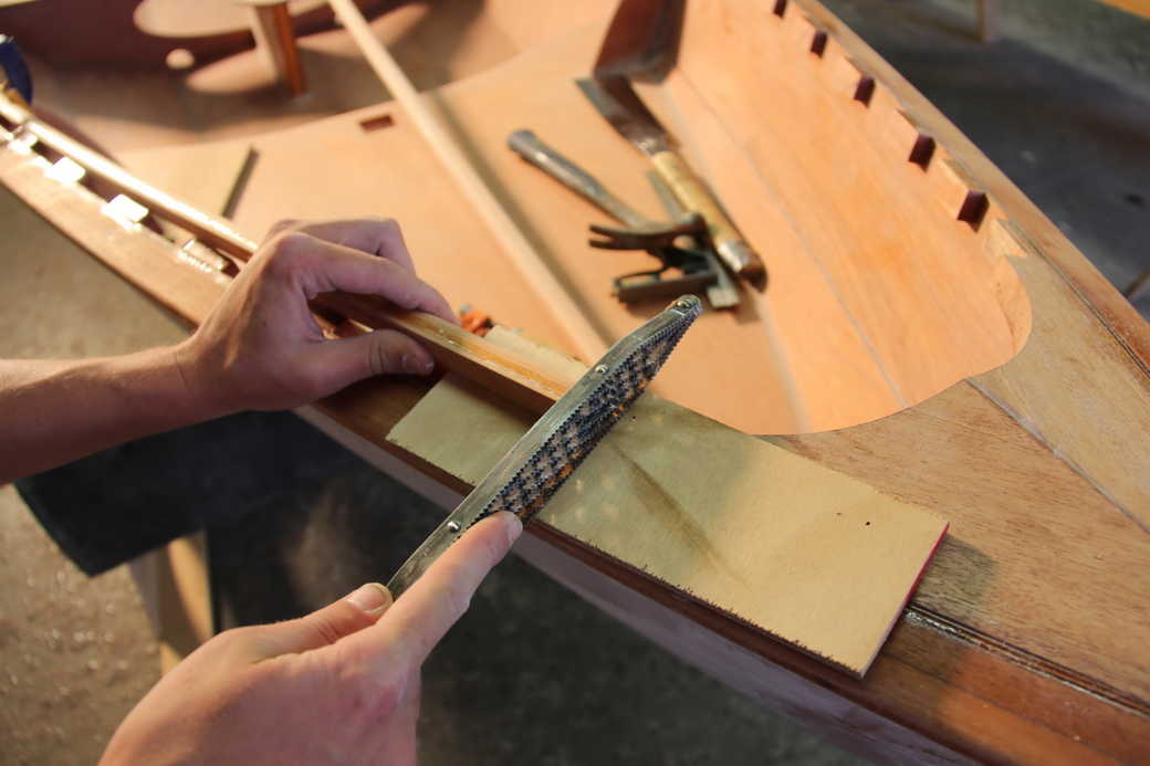 Use a rasp or sanding block to precisely fit the inwale to the breasthook notch