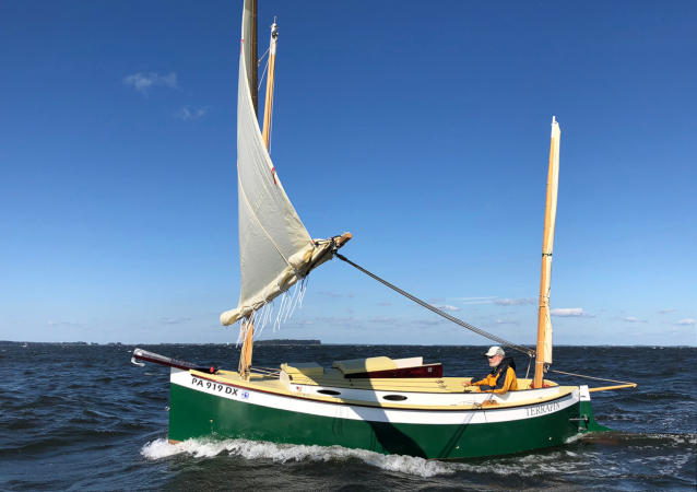 Autumn Leaves wooden canoe yawl designed for engineless coastal cruising by sail and oars