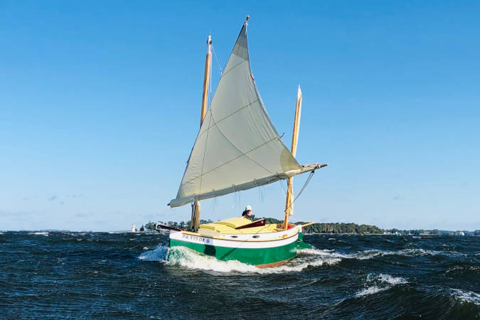 Autumn Leaves wooden canoe yawl designed for engineless coastal cruising by sail and oars