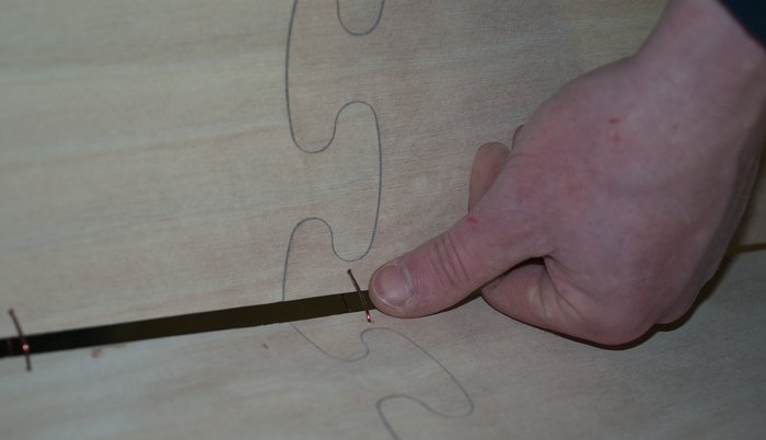 Stitching the canoe hull together