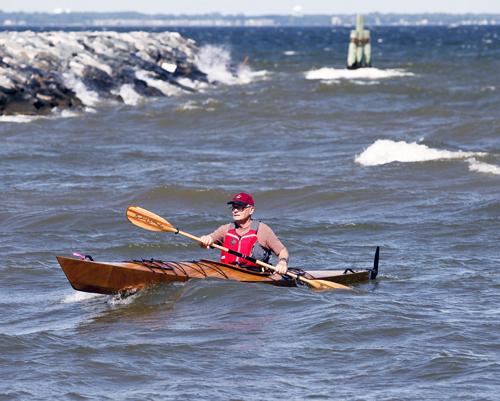 Fast surfing in a wooden kayak