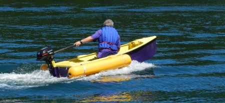 The Duo dinghy being driven by a small outboard motor