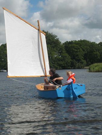 All of the family in a home made sailing boat