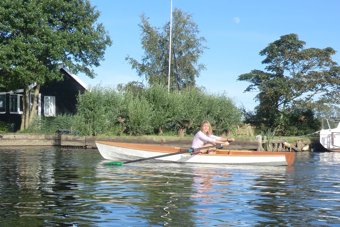 A single rower in the Fyne Scull wooden rowing boat