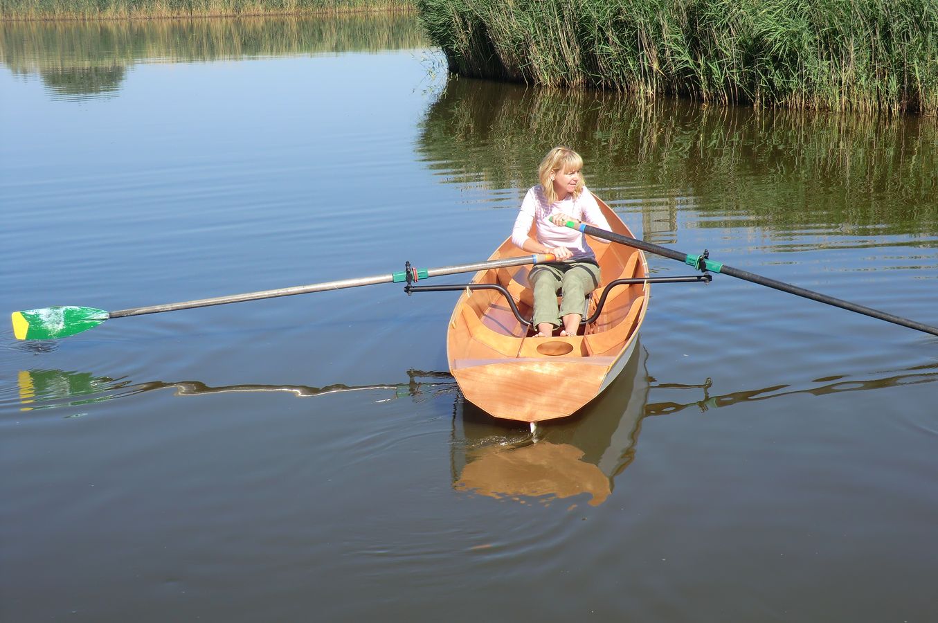 A single rower in the Fyne Scull wooden rowing boat