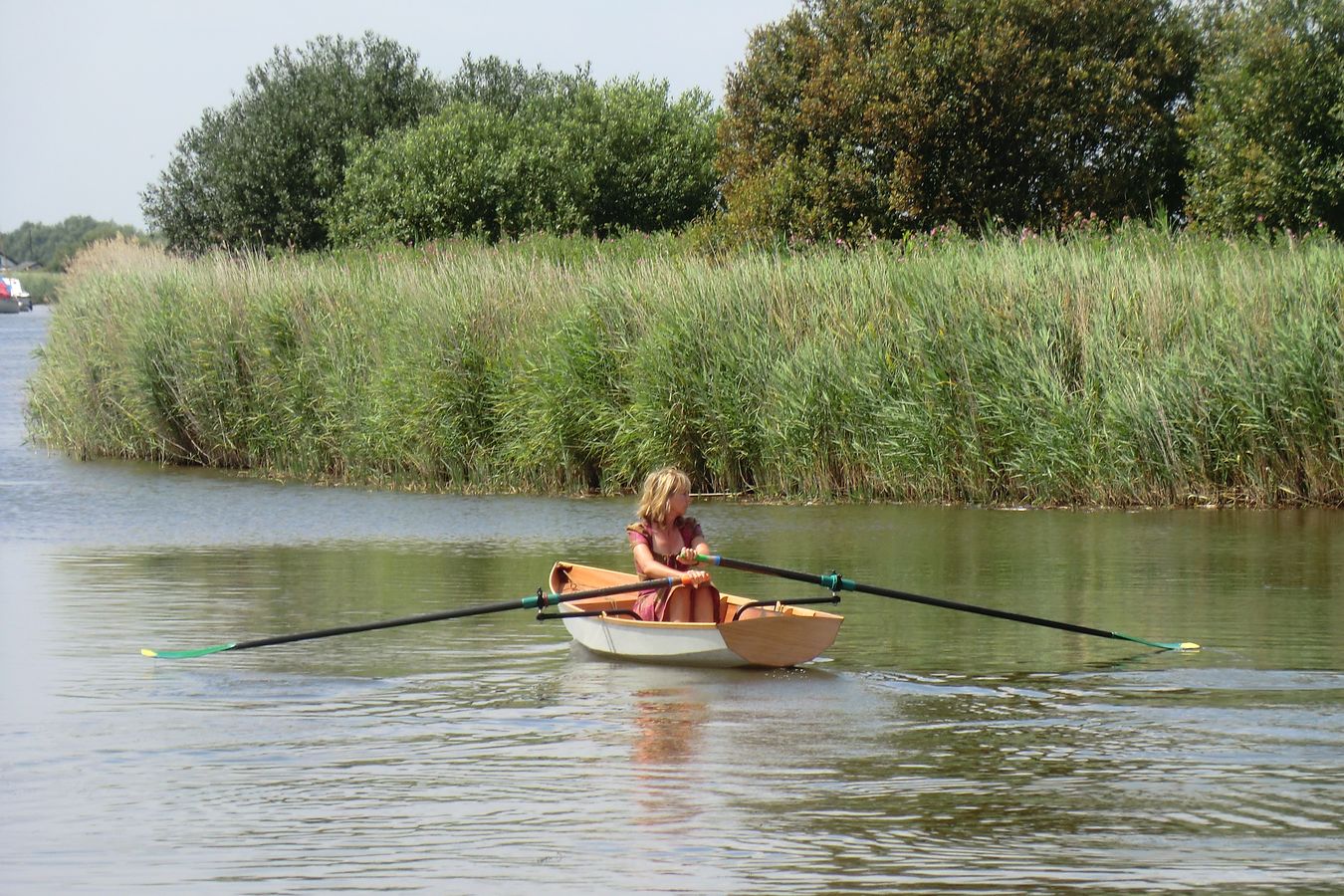 A single rower in the Fyne Scull wooden rowing boat
