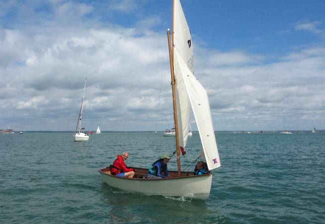Gaffling classic wooden sailing dinghy with a traditional gaff rig