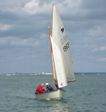 Gaffling classic wooden sailing dinghy with a traditional gaff rig