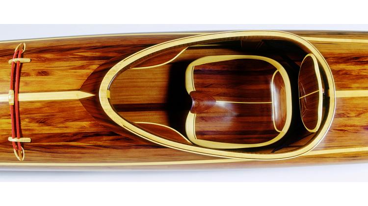 Carved wooden kayak seat for a strip-planked kayak
