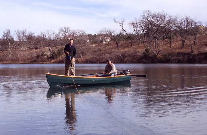 Fishing from a home made wooden motor boat built from plans from Fyne Boat Kits