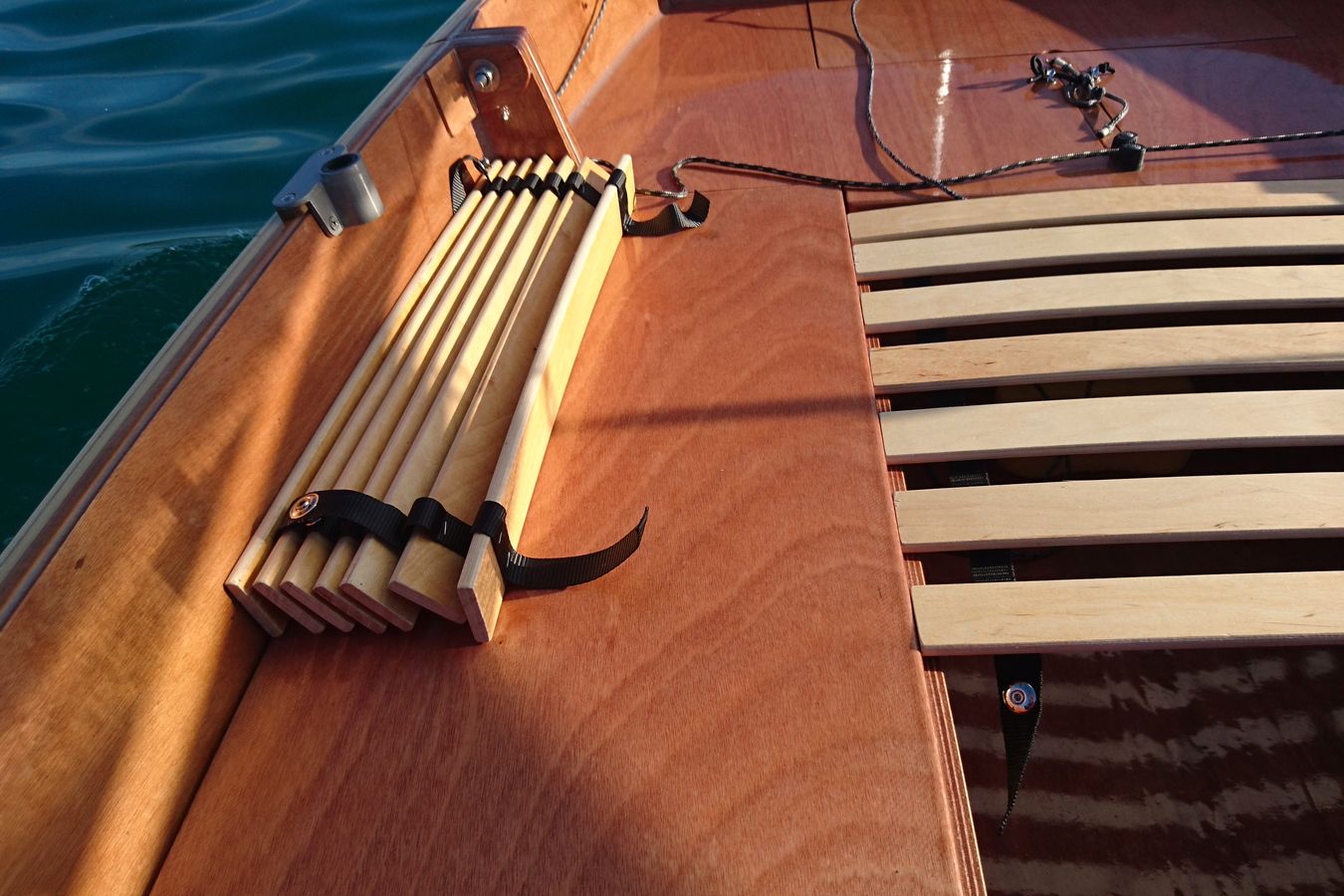 A slatted sleeping platform turns the Mebo 12 dinghy cockpit into a full-width sleeping platform