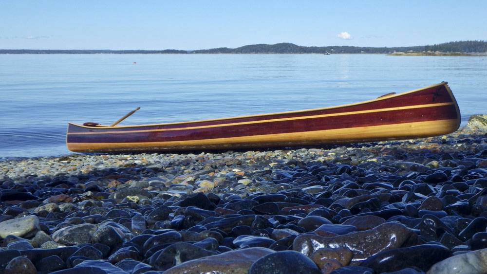 The Mystic River tandem canoe on a beach