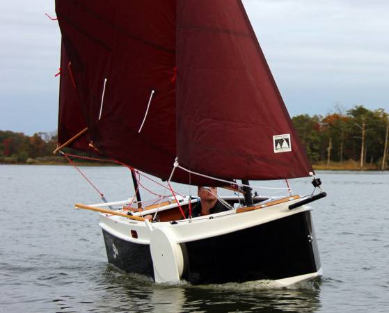 The Nesting Expedition Dinghy is a very compact wooden sailing boat for beach cruising