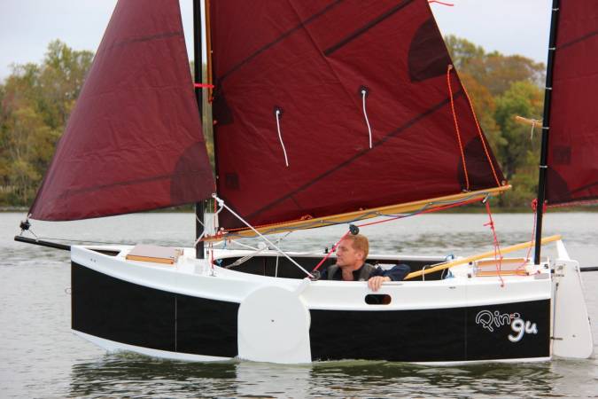 The Nesting Expedition Dinghy is a very compact wooden sailing boat for beach cruising