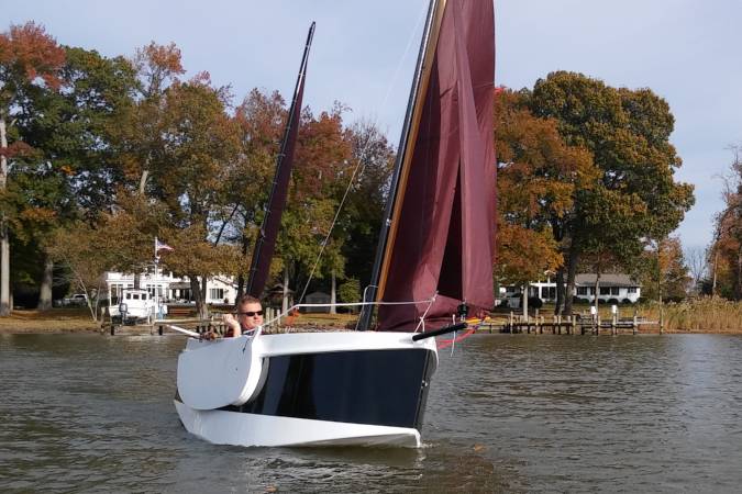 The Nesting Expedition Dinghy is a very compact wooden sailing boat for beach cruising