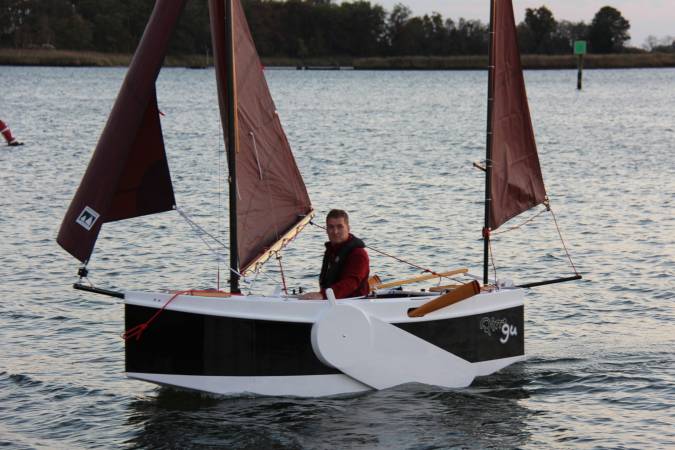 The Nesting Expedition Dinghy is a very compact wooden sailing boat for beach cruising