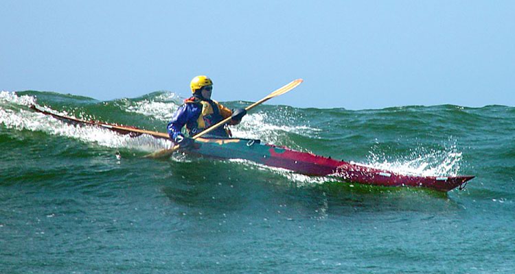 Surfing a Night Heron stitch-and-glue sea kayak