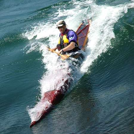 Surfing a Night Heron stitch-and-glue sea kayak