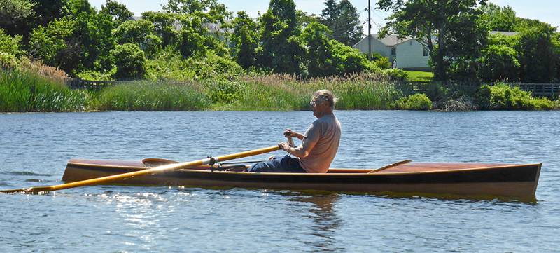 The Noank Pulling Boat is an efficient wooden sculling boat suitable for open water expeditions, using a drop-in sliding seat rowing unit