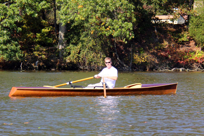 The Noank Pulling Boat is an efficient wooden sculling boat suitable for open water expeditions, using a drop-in sliding seat rowing unit