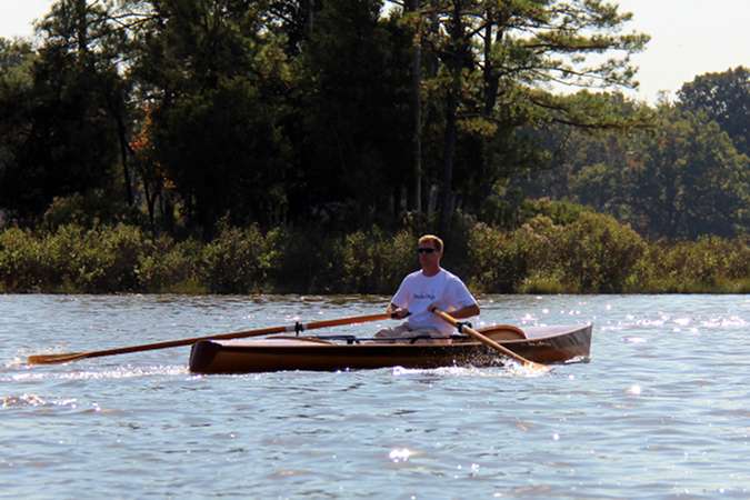 The Noank Pulling Boat is an efficient wooden sculling boat suitable for open water expeditions, using a drop-in sliding seat rowing unit