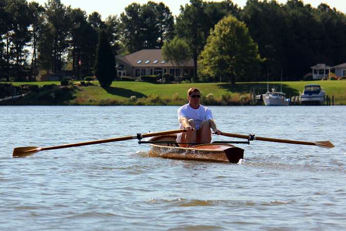 The Noank Pulling Boat is an efficient wooden sculling boat suitable for open water expeditions, using a drop-in sliding seat rowing unit