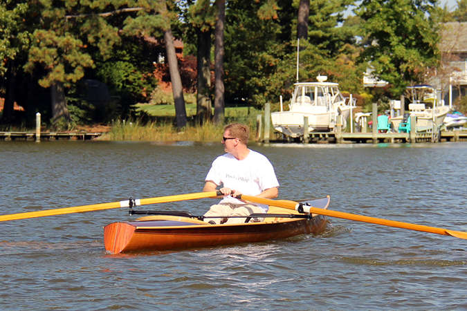 The Noank Pulling Boat is an efficient wooden sculling boat suitable for open water expeditions, using a drop-in sliding seat rowing unit