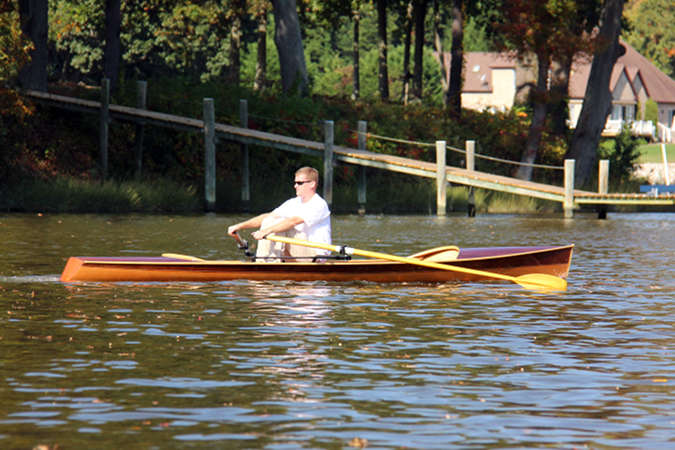 The Noank Pulling Boat is an efficient wooden sculling boat suitable for open water expeditions, using a drop-in sliding seat rowing unit