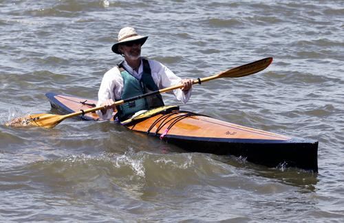 Having fun surfing in a wooden Pax kayak