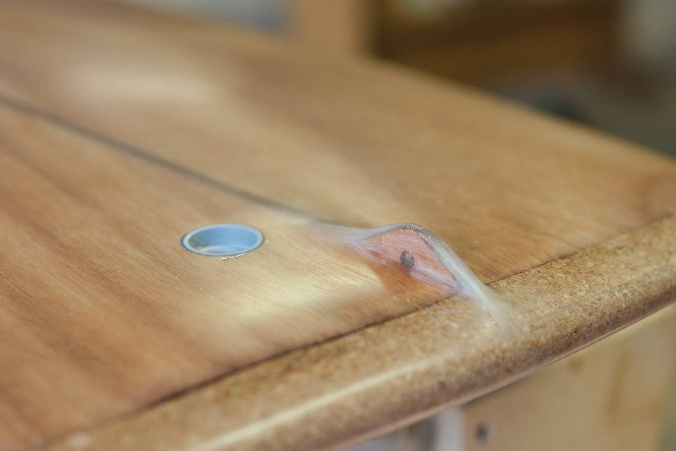 The built-in leash attachment point on a Grain PlyBeam surfboard