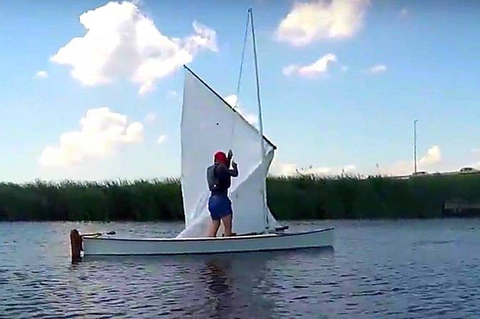 The Viola 14 sailing canoe has enough stability to stand up while hoisting sail