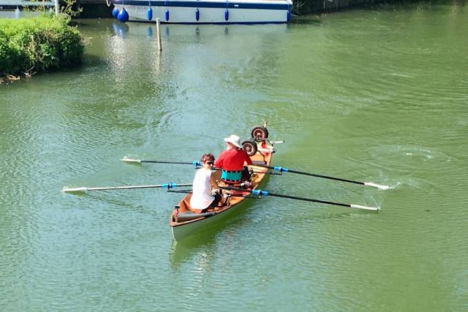 Tandem Wherry wooden rowing boat on the river Thames